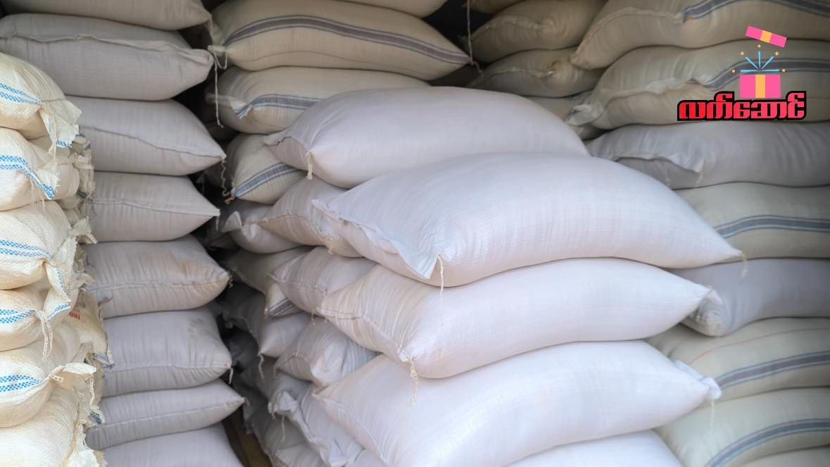 Stacks of white sacks of rice.